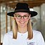 A blond student with round glasses and a forester’s hat