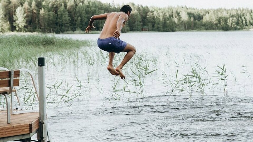 A student jumping into the lake.