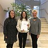 Auf dem Foto sind folgende Personen von links nach rechts zu sehen: Andrea Nallinger, stellvertretende Schulleiterin der RoMed-Berufsfachschule für Physiotherapie, Staatspreisträgerin Lea Rossmann, Prof. Dr. Sabine Ittlinger, Studiengangleiterin des Studiengangs Physiotherapie