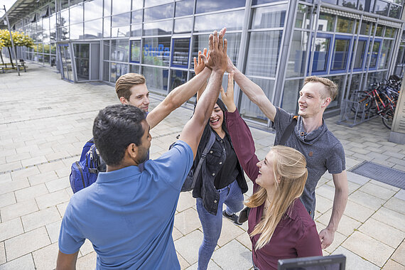 Group of students dong high fiving