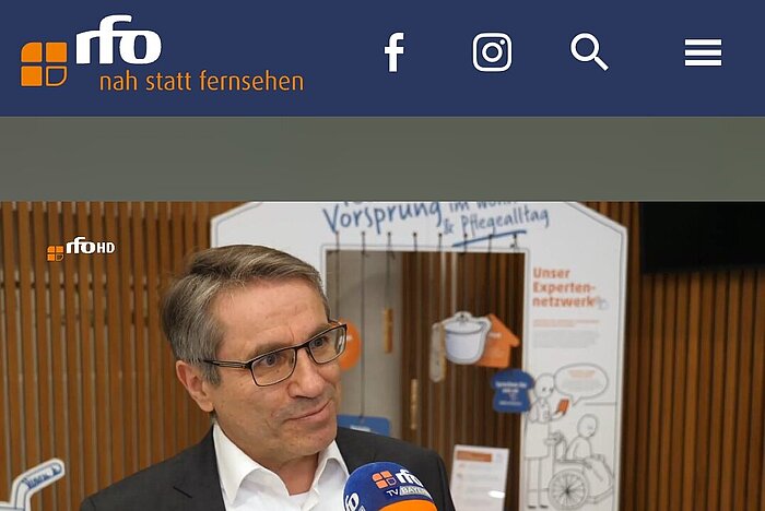 Prof. Benstetter im Interview. Im Hintergrund die Wanderausstellung