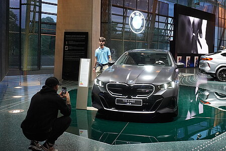 Students taking pictures at the BMW Welt in Munich.