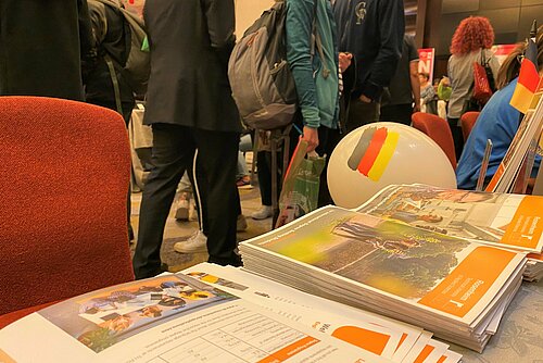 A booth at an international fair with visiting guests