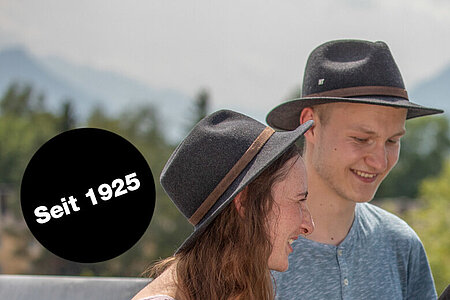 Rosenheim Wood Technology students wearing their traditional „Hats“ in front of the Alps